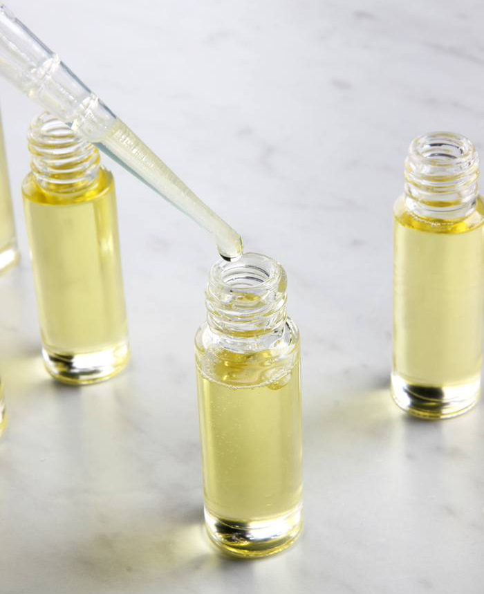 dropping oil into bottle | bramble berry