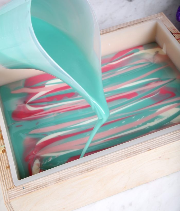 pouring cold process soap into a mold