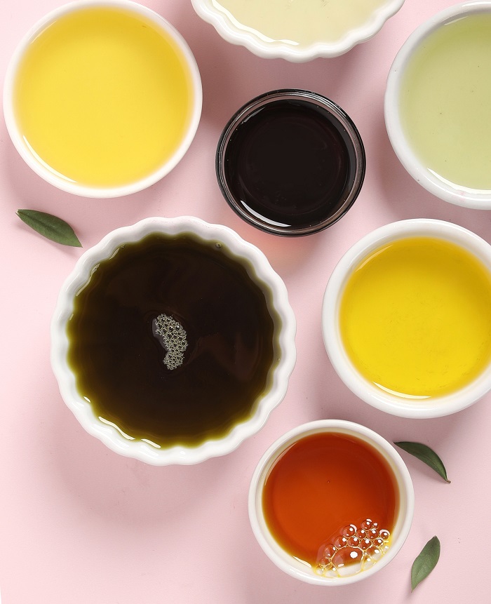 Oils for Soaks and Scrubs Small bowls of different oils on a white
surface