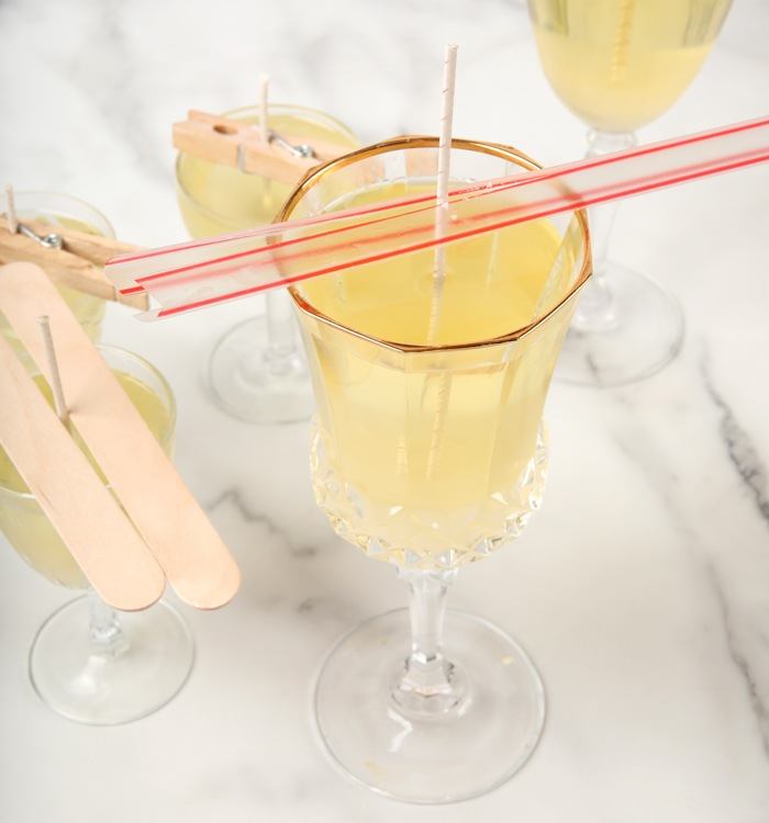 holding
                wick in place with a straw | bramble berry