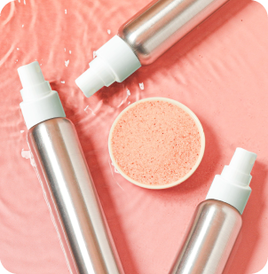 aluminum bottles, dish of pink sea salt, watery background