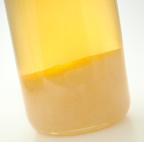 A bottle of fragrance oil with solid
                percipitate at the bottom