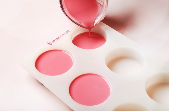 pouring
pink soap into a mold | Bramble Berry